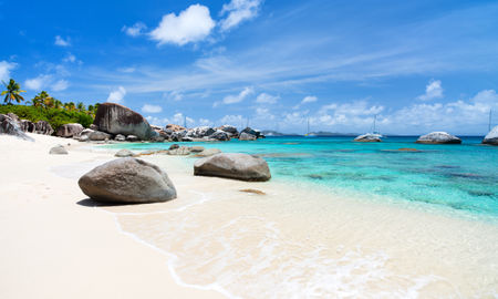 Beautiful tropical beach with white sand, turquoise ocean water and blue sky at Virgin Gorda, British Virgin Islands in Caribbean (Photo via shalamov / iStock / Getty Images Plus)