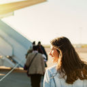 woman getting in to plane (Photo via VladTeodo / iStock / Getty Images Plus)