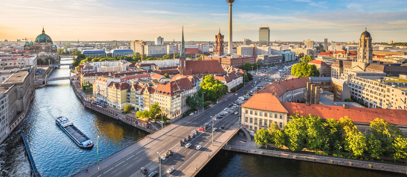 Aerial view of Berlin skyline with famous TV tower and Spree river in beautiful evening light at sunset, Germany. (photo via bluejayphoto/iStock/Getty Images Plus)