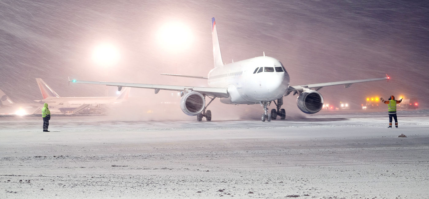 Image: Airplane taxiing at the airport amid a winter storm. (photo via iStock/Getty Images Plus/uatp2)