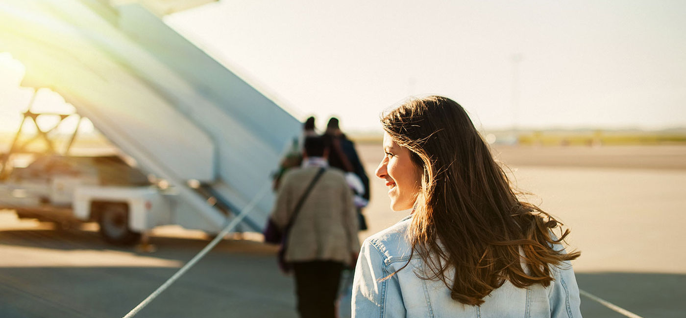 Image: woman getting in to plane (Photo via VladTeodo / iStock / Getty Images Plus)