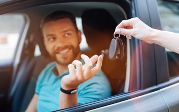 Car rental customer receiving keys