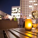 A glass of wine at a rooftop bar